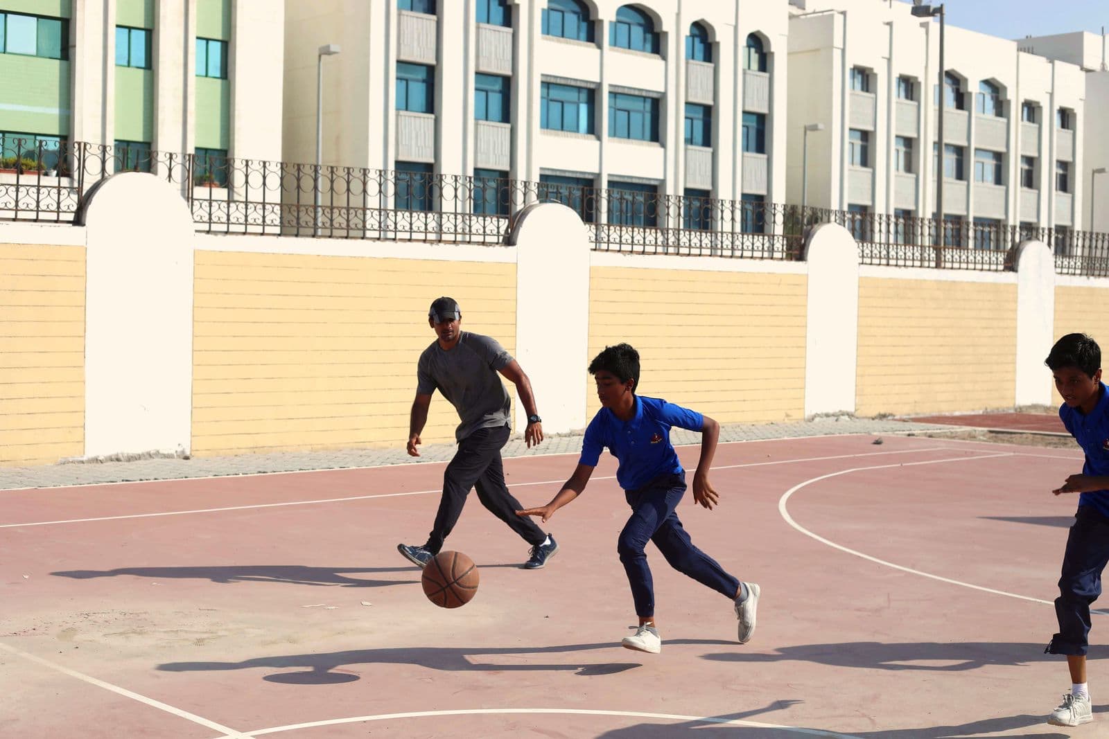 Students playing basketball on the outdoor court