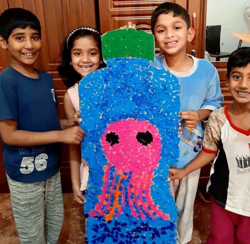Pupils showing a jellyfish made from recycled bottle caps