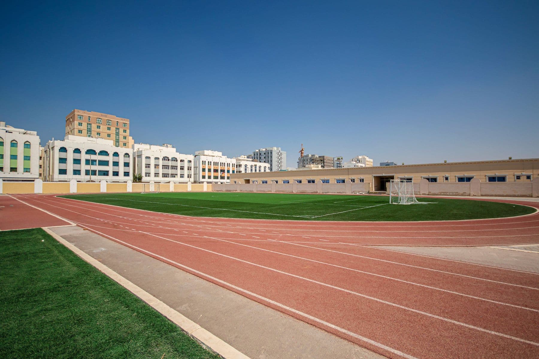 The running track curving around the school's football field