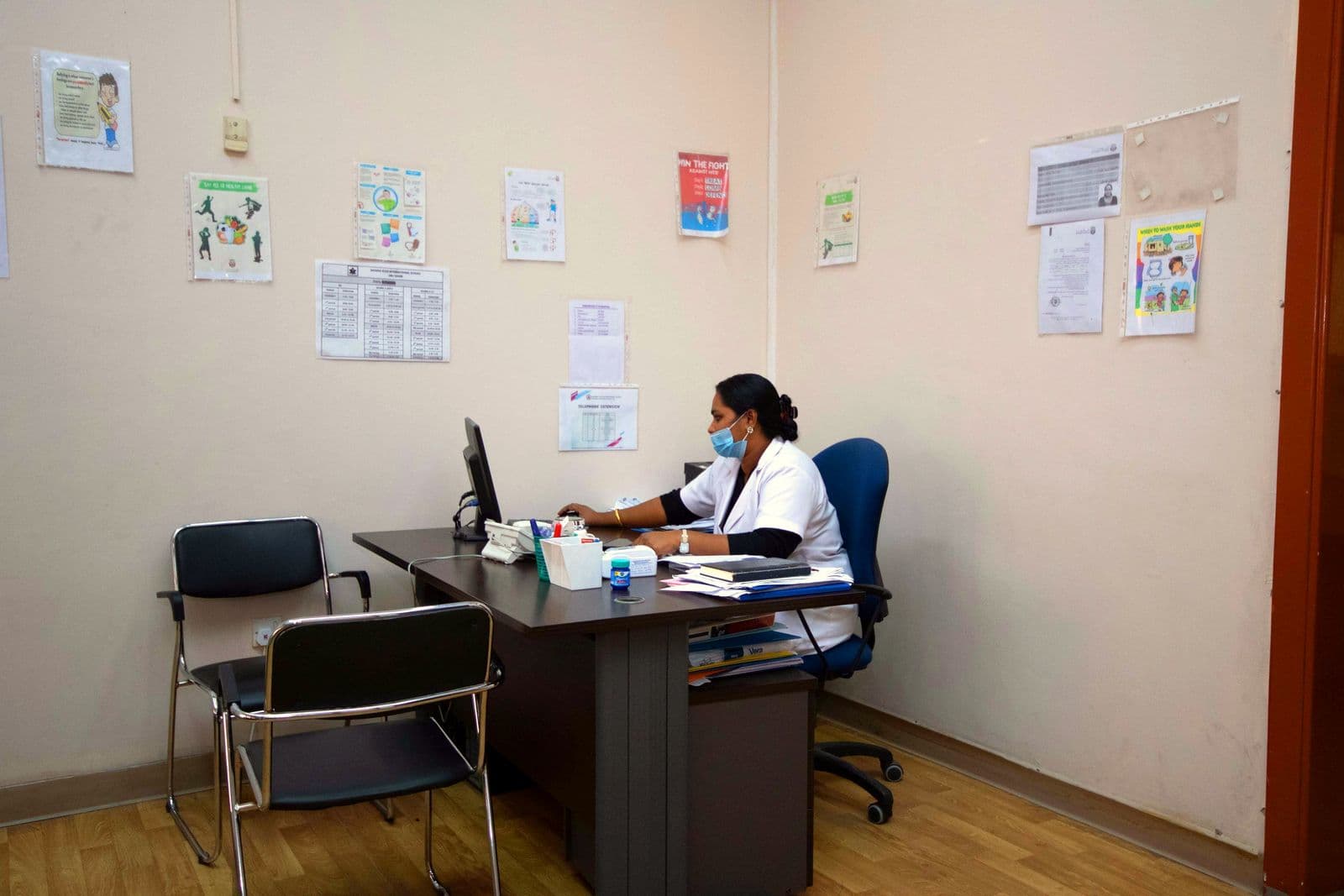 The school nurse at her desk in the clinic