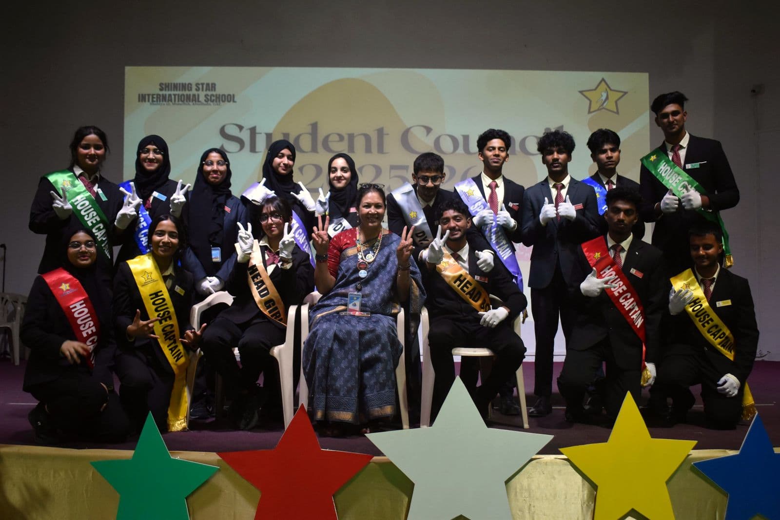 The Student Council and staff on stage after the investiture