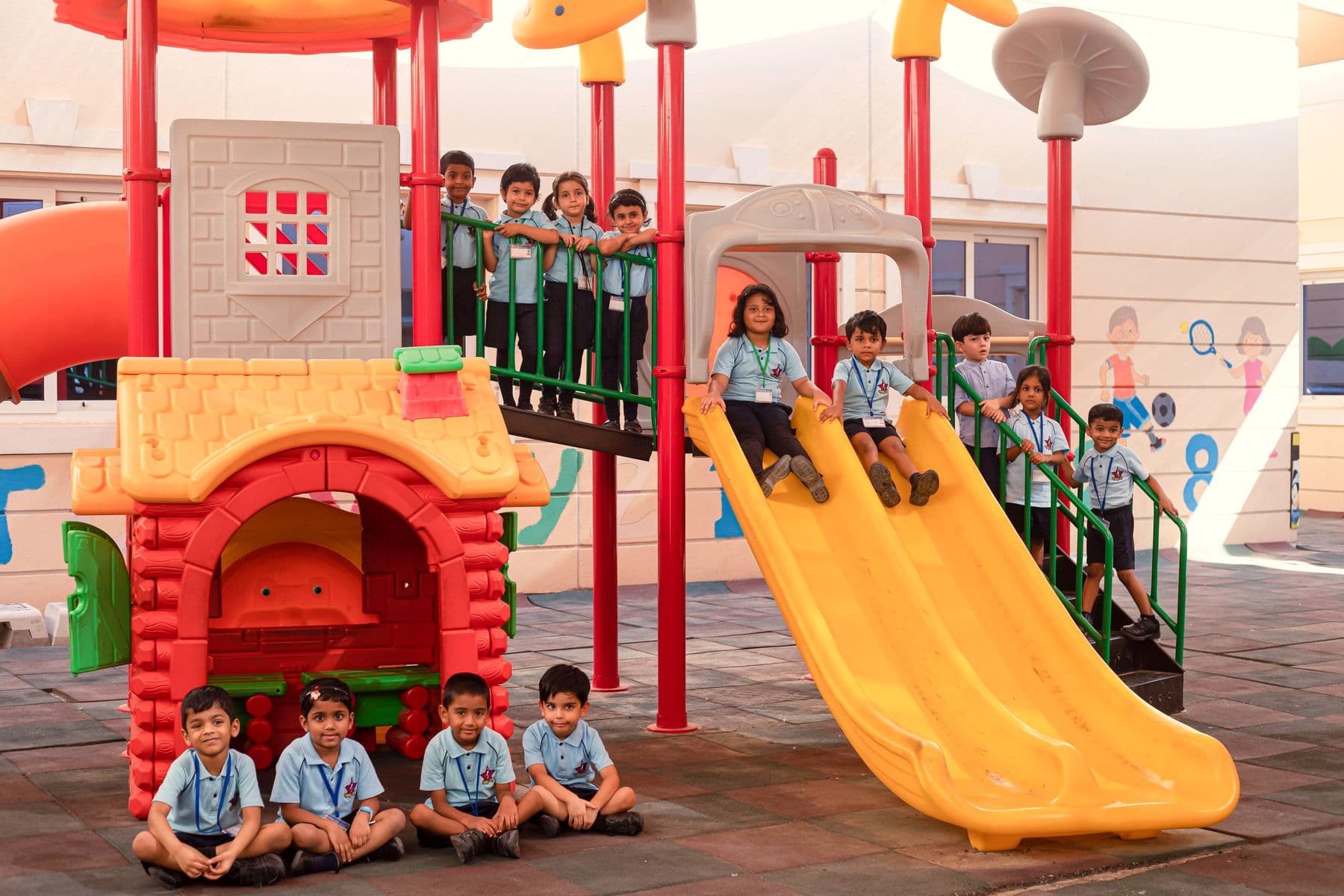Children on the slide and climbing frame of the kindergarten playground